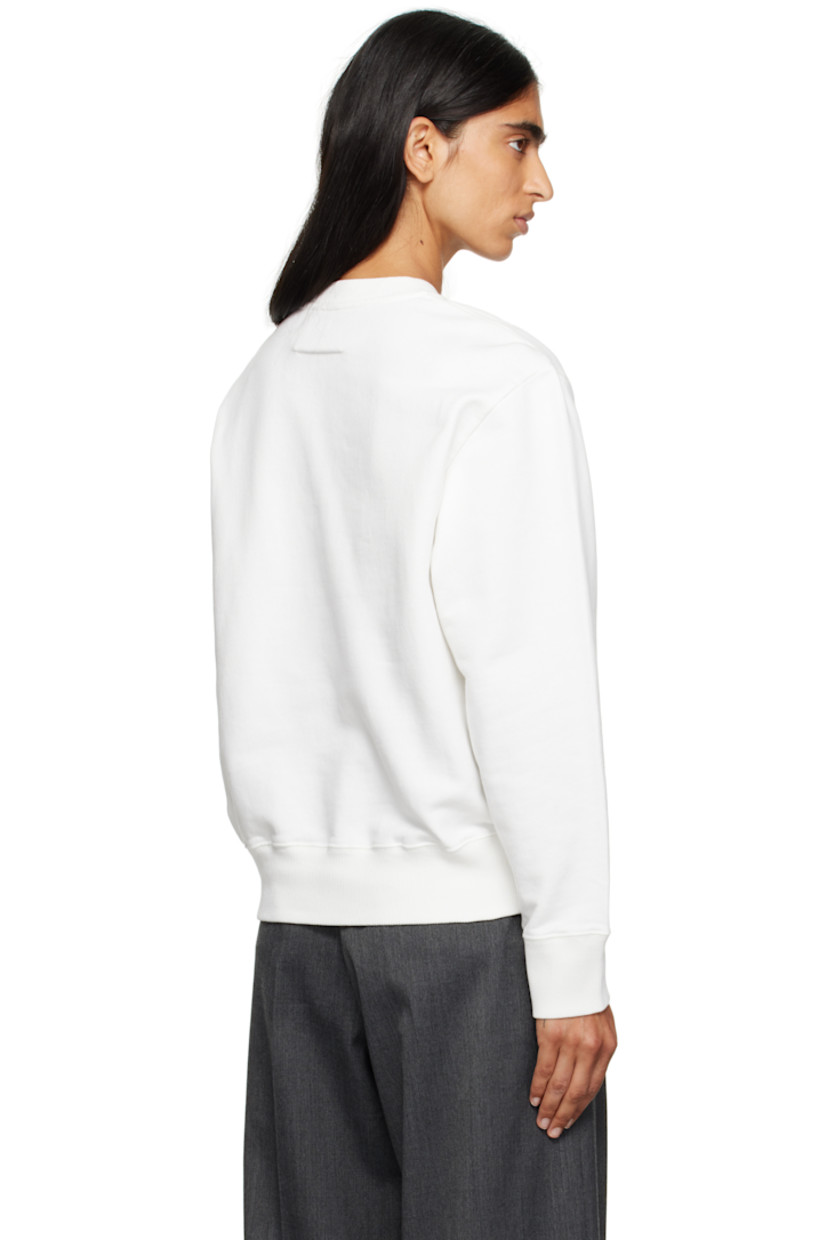 Cotton French terry sweatshirt.

· Rib-knit crewneck, hem, and cuffs
· Logo patch at chest
· White stitching at back collar

Supplier color: Off white