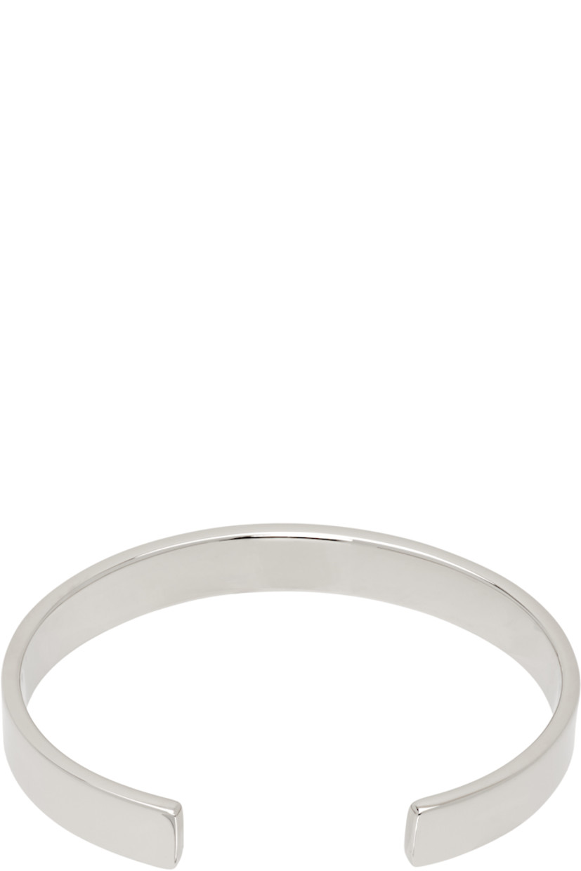 Open cuff bracelet in silver-tone brass. Logo engraved at face.

Supplier color: Polished palladio