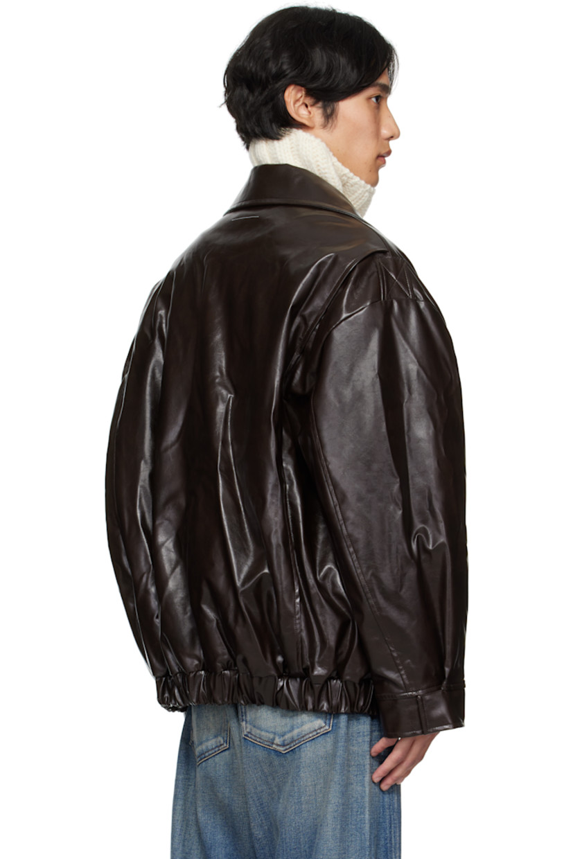 Insulated grained faux-leather jacket. 

· Spread collar
· Zip closure
· Flap pockets at front 
· Elasticized hem and cuffs
· White stitching at back collar 
· Welt pocket at interior 
· Full satin twill lining 

Supplier color: Burgundy