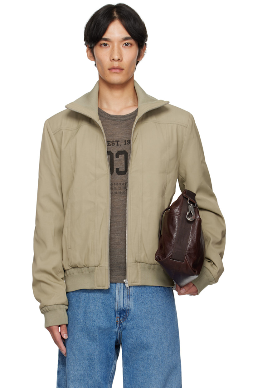 Insulated viscose twill jacket. 

· Rib-knit stand collar, hem, and cuffs
· Zip closure
· Welt pockets at front 
· White stitching at back collar 
· Welt pocket at interior 
· Full satin lining 

Supplier color: Trench beige