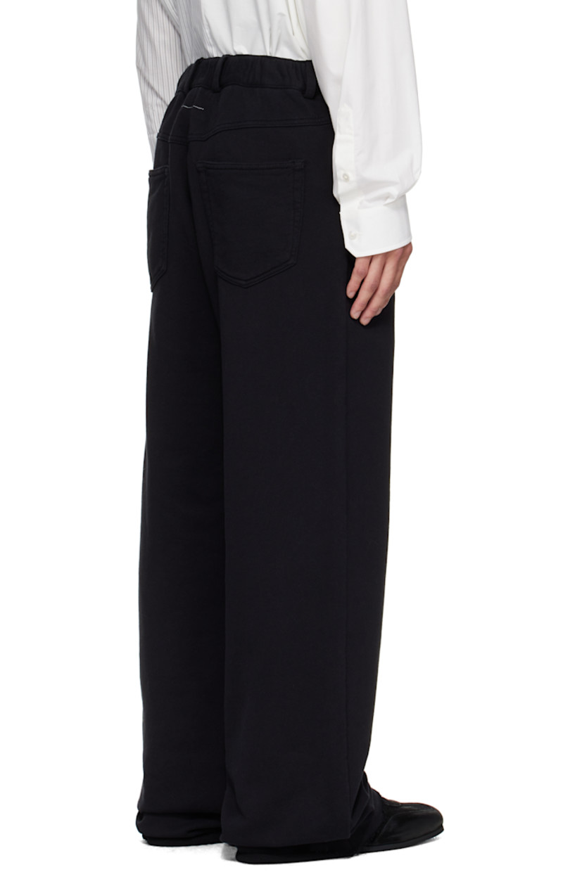 French terry trousers.

· Wide-leg 
· Concealed drawstring at elasticized waistband
· Belt loops
· Zip fly 
· Five-pocket styling
· Raw edge at cuffs 
· White stitching at back waist 

Supplier color: Black