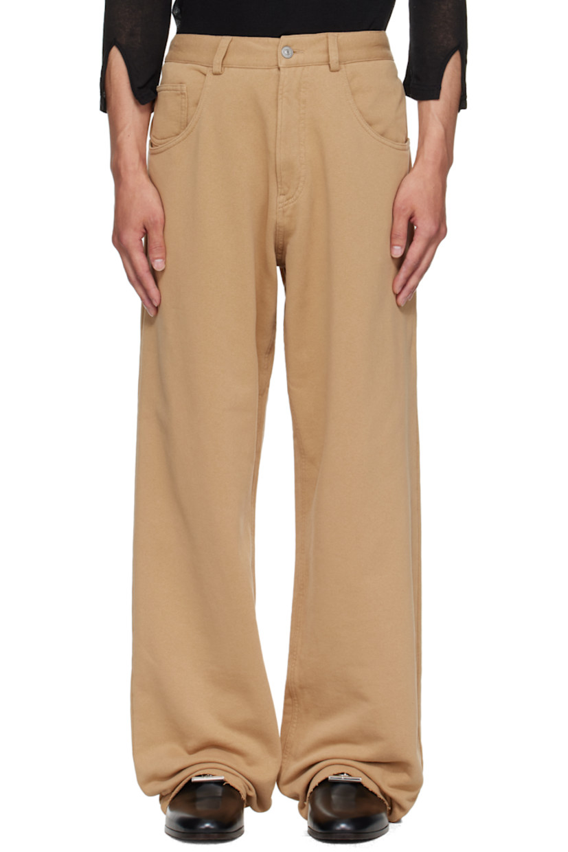 French terry trousers.

· Wide-leg 
· Concealed drawstring at elasticized waistband
· Belt loops
· Zip fly 
· Five-pocket styling
· Raw edge at cuffs 
· White stitching at back waist 

Supplier color: Ocre