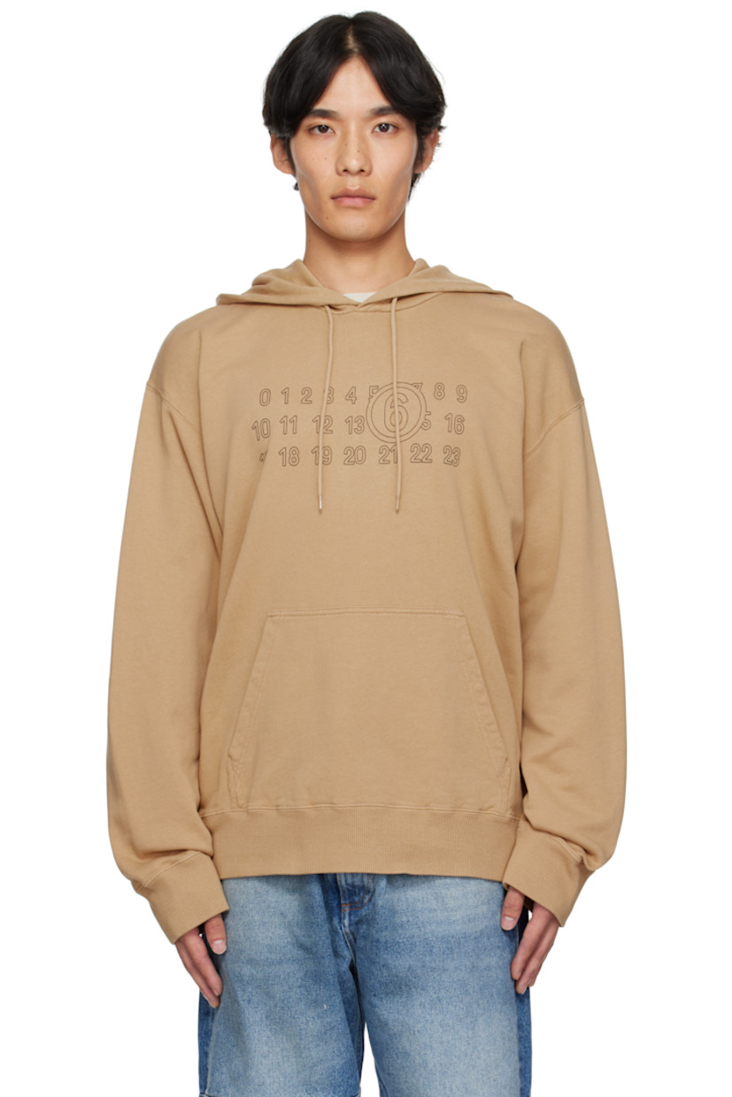 French terry hoodie. 

· Drawstring at hood
· Logo printed at front 
· Kangaroo pocket 
· Rib-knit hem and cuffs
· Dropped shoulders
· White stitching at back collar 

Supplier color: Ocre
