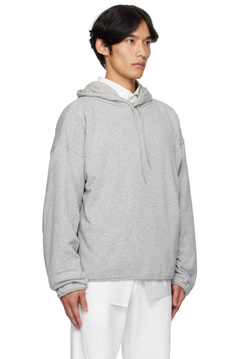 Cotton-blend French terry hoodie. 

· Drawstring at hood
· Seam pockets at waist
· Dropped shoulders
· White stitching at back collar 
· Full cotton jersey lining

Supplier color: Light grey melange