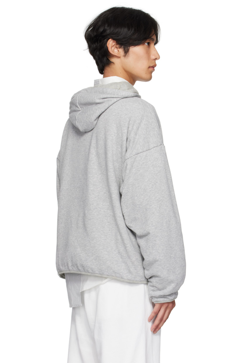Cotton-blend French terry hoodie. 

· Drawstring at hood
· Seam pockets at waist
· Dropped shoulders
· White stitching at back collar 
· Full cotton jersey lining

Supplier color: Light grey melange