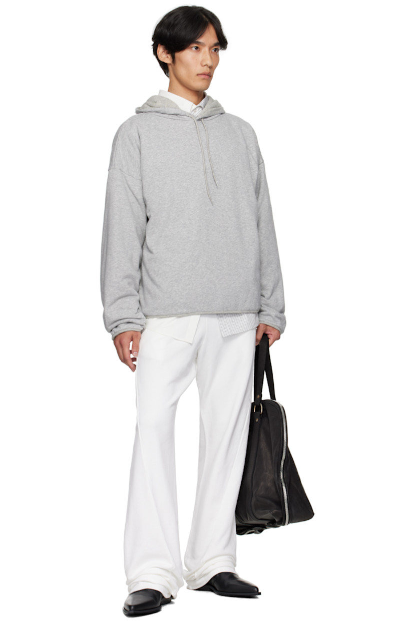 Cotton-blend French terry hoodie. 

· Drawstring at hood
· Seam pockets at waist
· Dropped shoulders
· White stitching at back collar 
· Full cotton jersey lining

Supplier color: Light grey melange