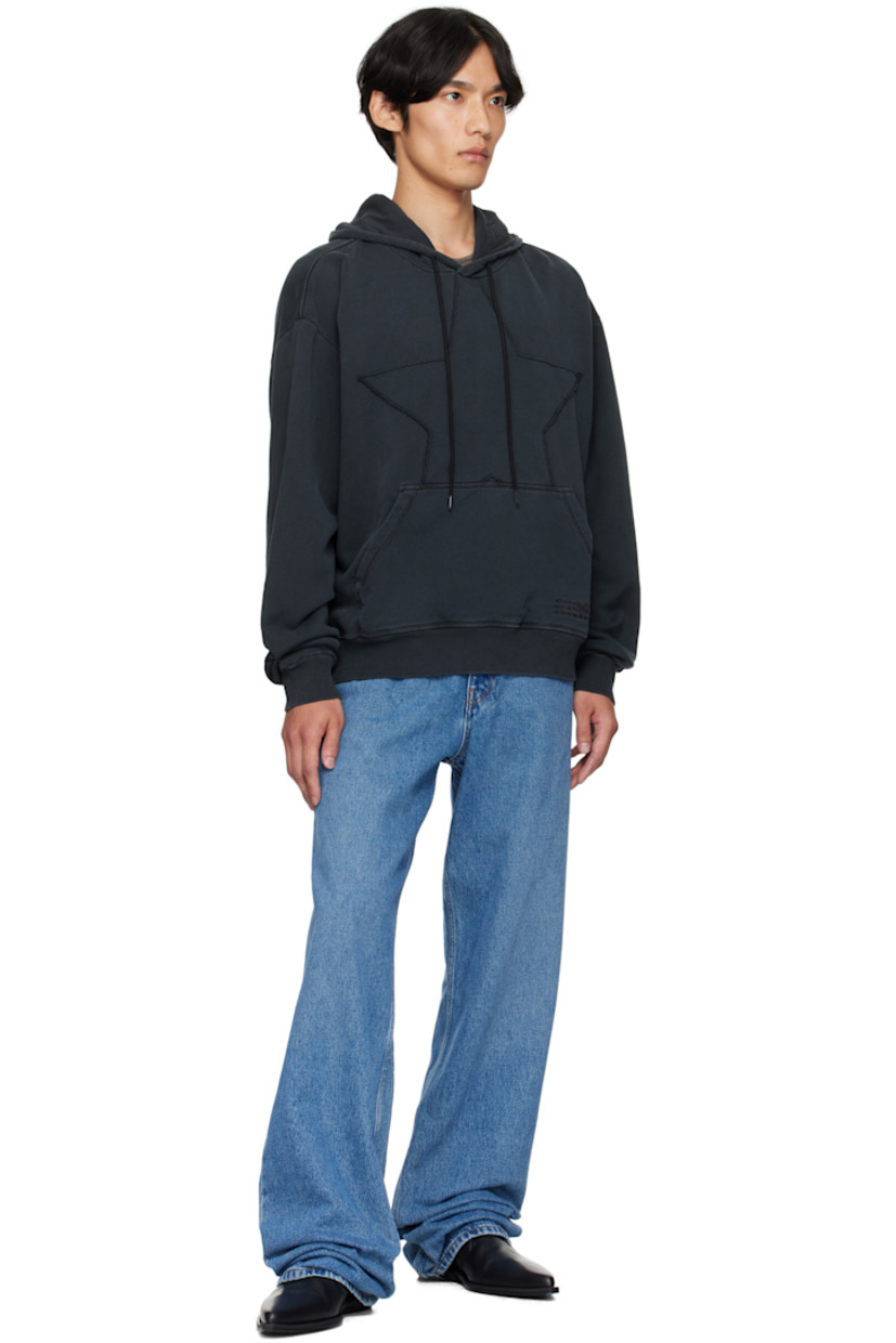 French terry hoodie. 

· Drawstring at hood
· Graphic appliqué with raw edge at front 
· Kangaroo pocket
· Rib-knit hem and cuffs
· Dropped shoulders
· White stitching at back collar 

Supplier color: Washed black