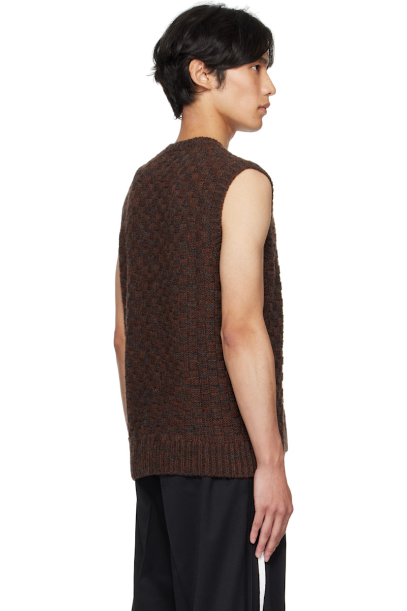 Knit virgin wool-blend sweater vest.

· Jacquard check pattern throughout 
· Rib-knit V-neck, hem, and armscyes
· Logo patch at front hem 
· White stitching at back collar 

Supplier color: Dark grey melange