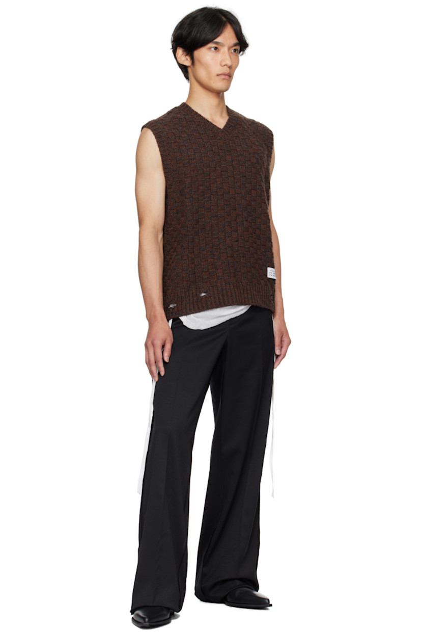 Knit virgin wool-blend sweater vest.

· Jacquard check pattern throughout 
· Rib-knit V-neck, hem, and armscyes
· Logo patch at front hem 
· White stitching at back collar 

Supplier color: Dark grey melange