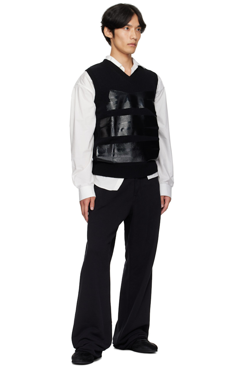 Knit wool-blend sweater. 

· Rib-knit V-neck, hem, and armscyes
· Bonded detailing at front 
· White stitching at back collar 

Supplier color: Black