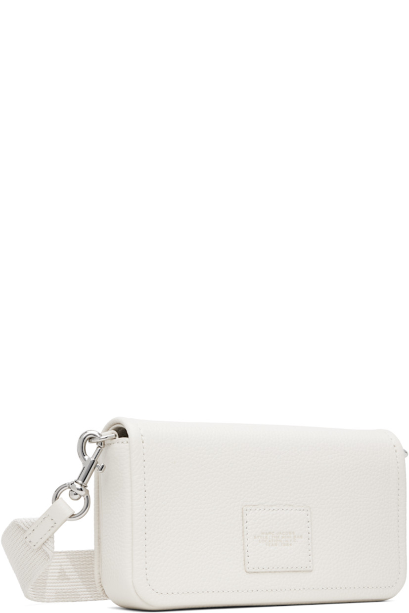 Structured pebble-grained leather shoulder bag in off-white.

· Adjustable and detachable logo-woven crossbody strap
· Text and logo embossed at face
· Logo patch at back face
· Magnetic flap
· Patch pocket at interior
· Eight card slots 
· Twill lining
· Logo-engraved silver-tone hardware
· H5" x W8" x D2"

Part of THE™ collection.

Supplier color: Cotton