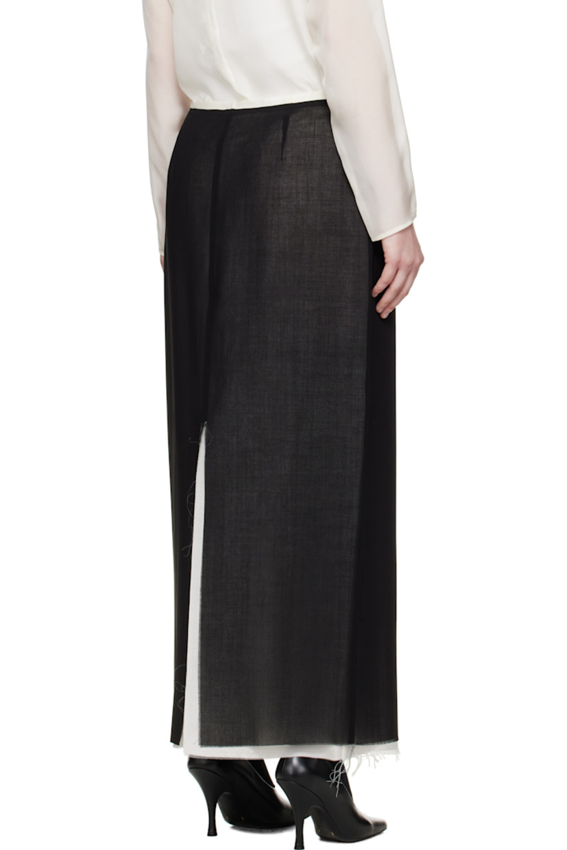 Virgin wool crêpe midi skirt.

· Layered construction
· Raw edge at hem
· Zip closure at side seam
· Central vent at back hem
· Full silk crêpe lining

Supplier color: Black/Off white