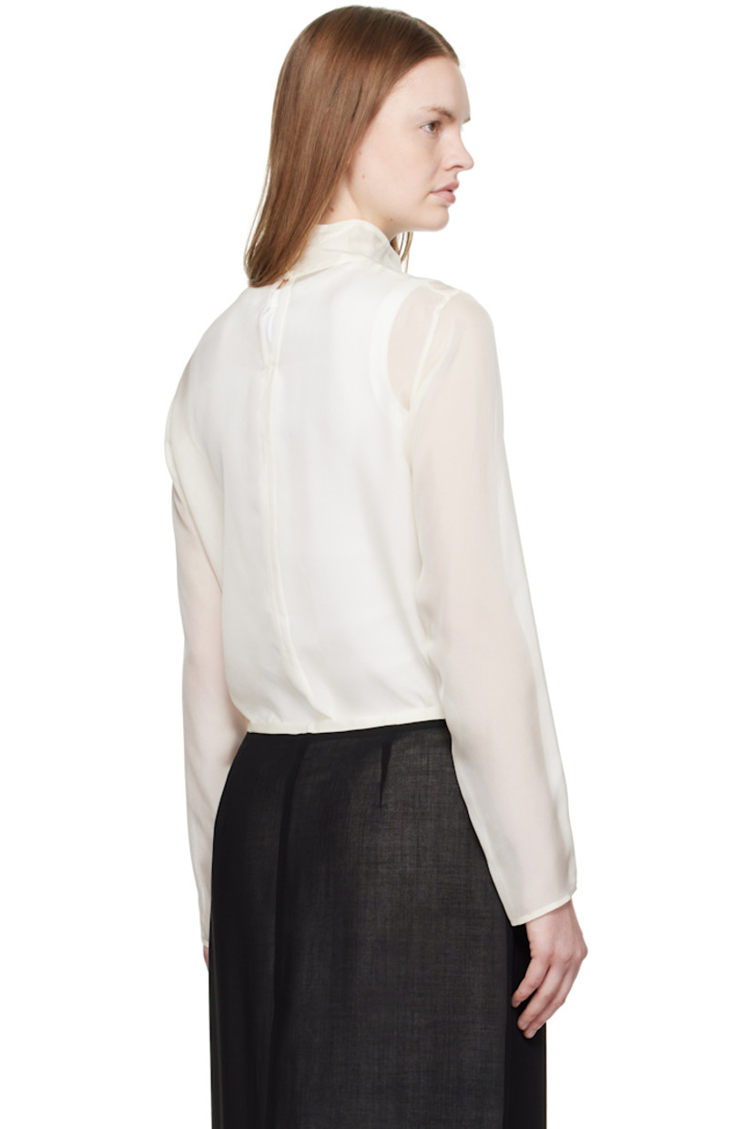 Sheer silk chiffon blouse.

· Button fastening at turtleneck
· Mother-of-pearl hardware

Supplier color: Off white