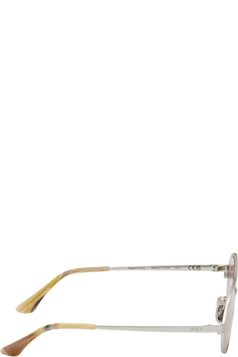 Oval metal-frame sunglasses in silver tone.

· Pink lenses
· Top bar
· Adjustable rubber nose pads
· Logo engraved at temples
· Acetate temple tips
· Includes pouch
· Size: 53.19 145

Supplier color: Boogie