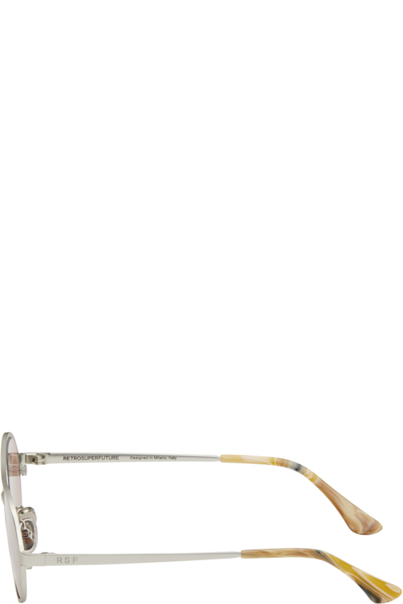 Oval metal-frame sunglasses in silver tone.

· Pink lenses
· Top bar
· Adjustable rubber nose pads
· Logo engraved at temples
· Acetate temple tips
· Includes pouch
· Size: 53.19 145

Supplier color: Boogie