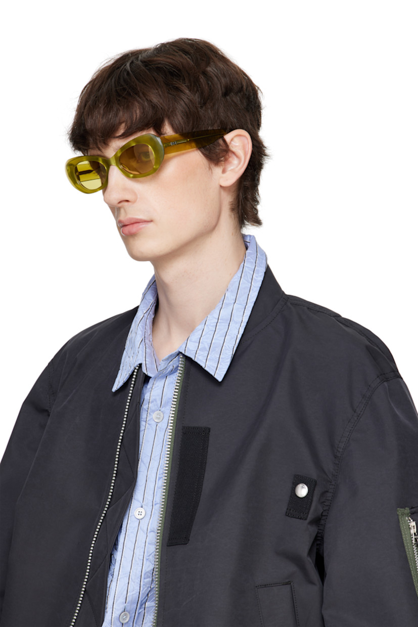 Oval semi-transparent acetate-frame sunglasses in yellow.

· Handcrafted
· Marbled pattern throughout
· Yellow lenses, category 1
· Integrated nose pads
· Logo hardware at temples
· Exposed core wires
· Includes pouch
· Size: 52.19 145

Supplier color: Mindless