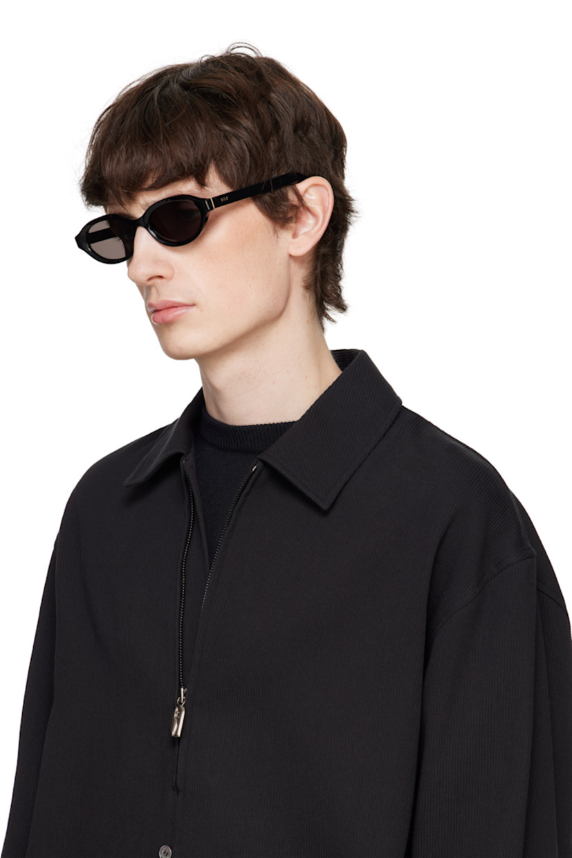 Oval acetate-frame sunglasses in black.

· Handcrafted
· Black lenses
· 100% UVA/UVB protection, category 3
· Integrated nose pads
· Inset logo hardware at temples
· Includes pouch
· Size: 54.17 145

Supplier color: Black