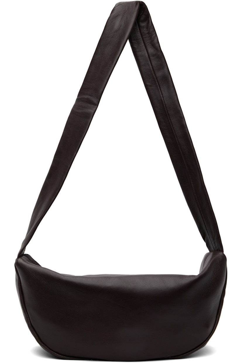 Buffed lambskin shoulder bag.

· Chrome-free and LWG-certified leather
· Fixed shoulder strap
· Zip closure
· Goatskin suede lining
· H6.75" x W13" x D4"

Supplier color: Port
