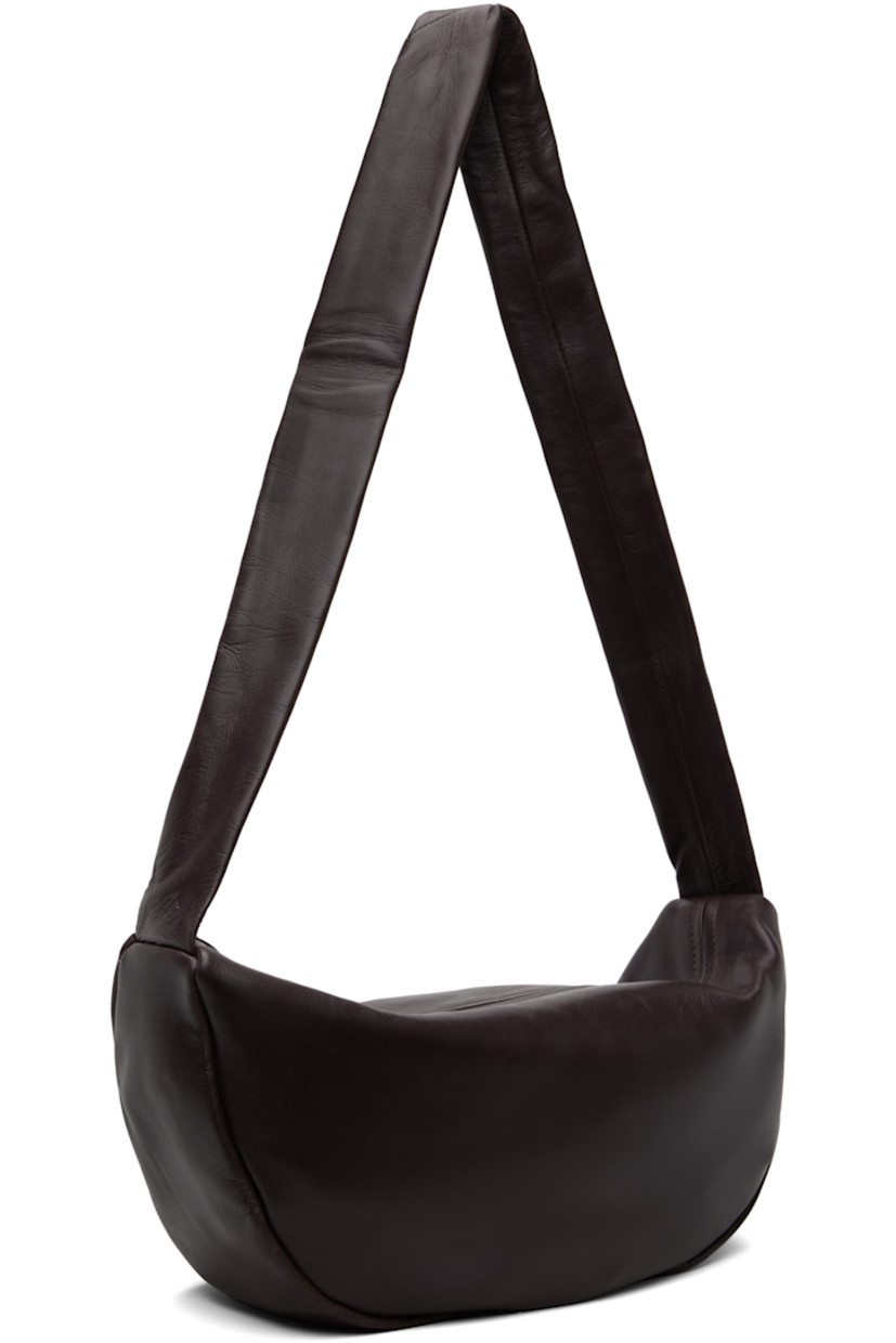 Buffed lambskin shoulder bag.

· Chrome-free and LWG-certified leather
· Fixed shoulder strap
· Zip closure
· Goatskin suede lining
· H6.75" x W13" x D4"

Supplier color: Port