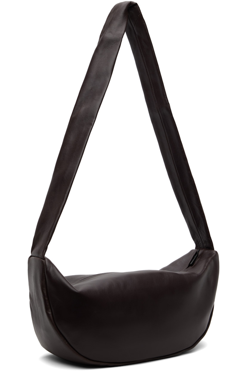 Buffed lambskin shoulder bag.

· Chrome-free and LWG-certified leather
· Fixed shoulder strap
· Zip closure
· Goatskin suede lining
· H6.75" x W13" x D4"

Supplier color: Port