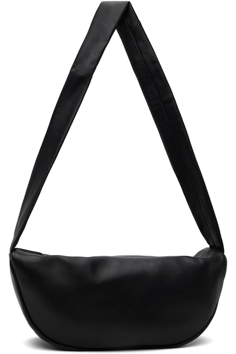 Vegetable-tanned buffed lambskin shoulder bag.

· LWG-certified leather
· Fixed shoulder strap
· Zip closure
· Goatskin suede lining
· H6.75" x W13" x D4"

Supplier color: Black