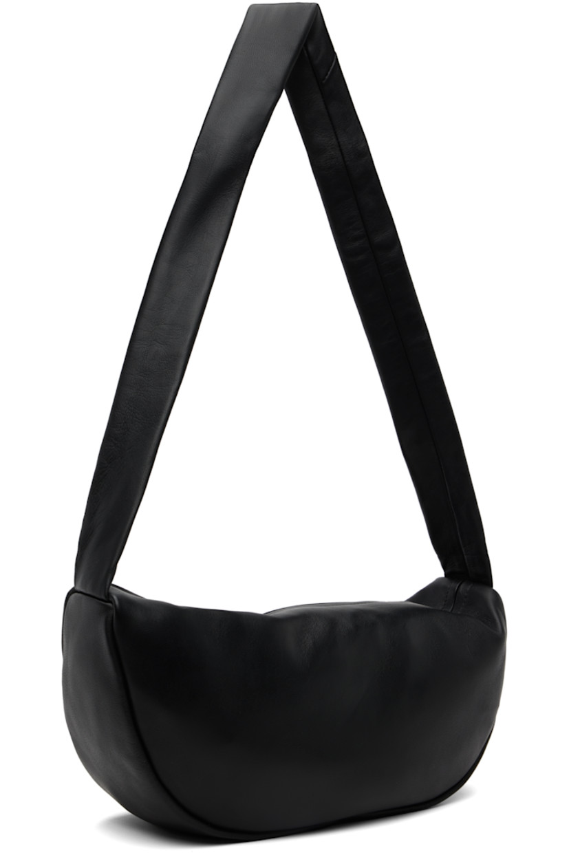 Vegetable-tanned buffed lambskin shoulder bag.

· LWG-certified leather
· Fixed shoulder strap
· Zip closure
· Goatskin suede lining
· H6.75" x W13" x D4"

Supplier color: Black