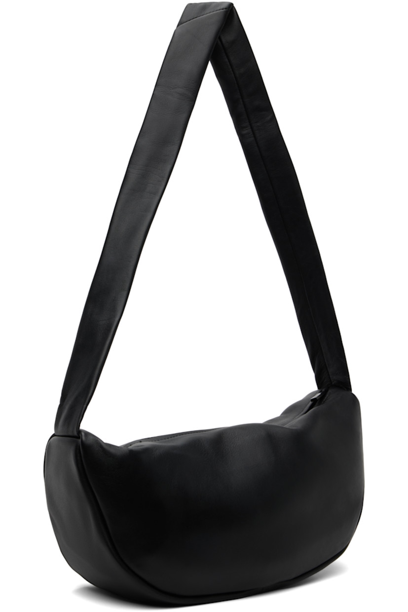 Vegetable-tanned buffed lambskin shoulder bag.

· LWG-certified leather
· Fixed shoulder strap
· Zip closure
· Goatskin suede lining
· H6.75" x W13" x D4"

Supplier color: Black