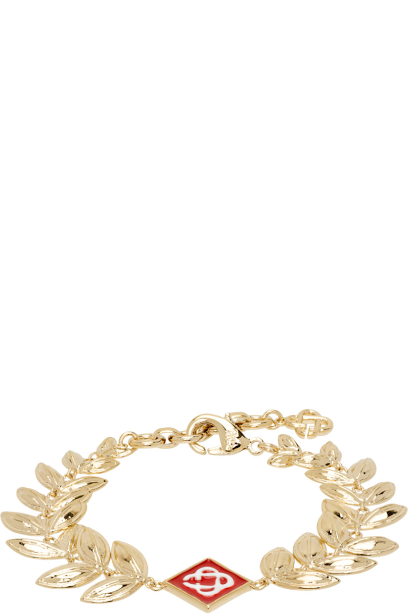 Modified cable chain bracelet in gold-tone brass.

· Enameled logo charm at face
· Logo charm at adjustable lobster clasp 
· L8"

Supplier color: Gold/Red