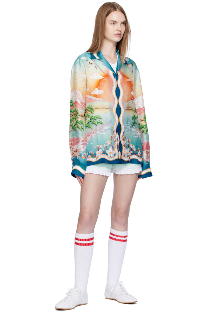 Silk satin shirt. 

· Graphics printed throughout
· Button fastening at open spread collar
· Concealed button closure
· Patch pocket at chest
· Logo printed at chest and back
· Buttoned barrel cuffs
· Logo-engraved hardware

Supplier color: Multicolour