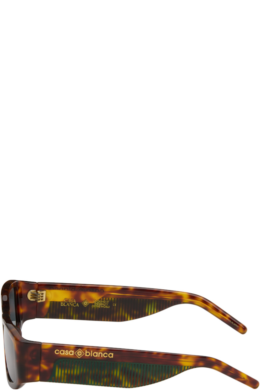 Rectangular semi-transparent tortoiseshell acetate-frame sunglasses.

· Green lenses
· 100% UVA/UVB protection
· Integrated nose pads
· Logo stamp at temples
· Exposed core wires
· Includes case
· Size: 57.16 140

Supplier color: Brown