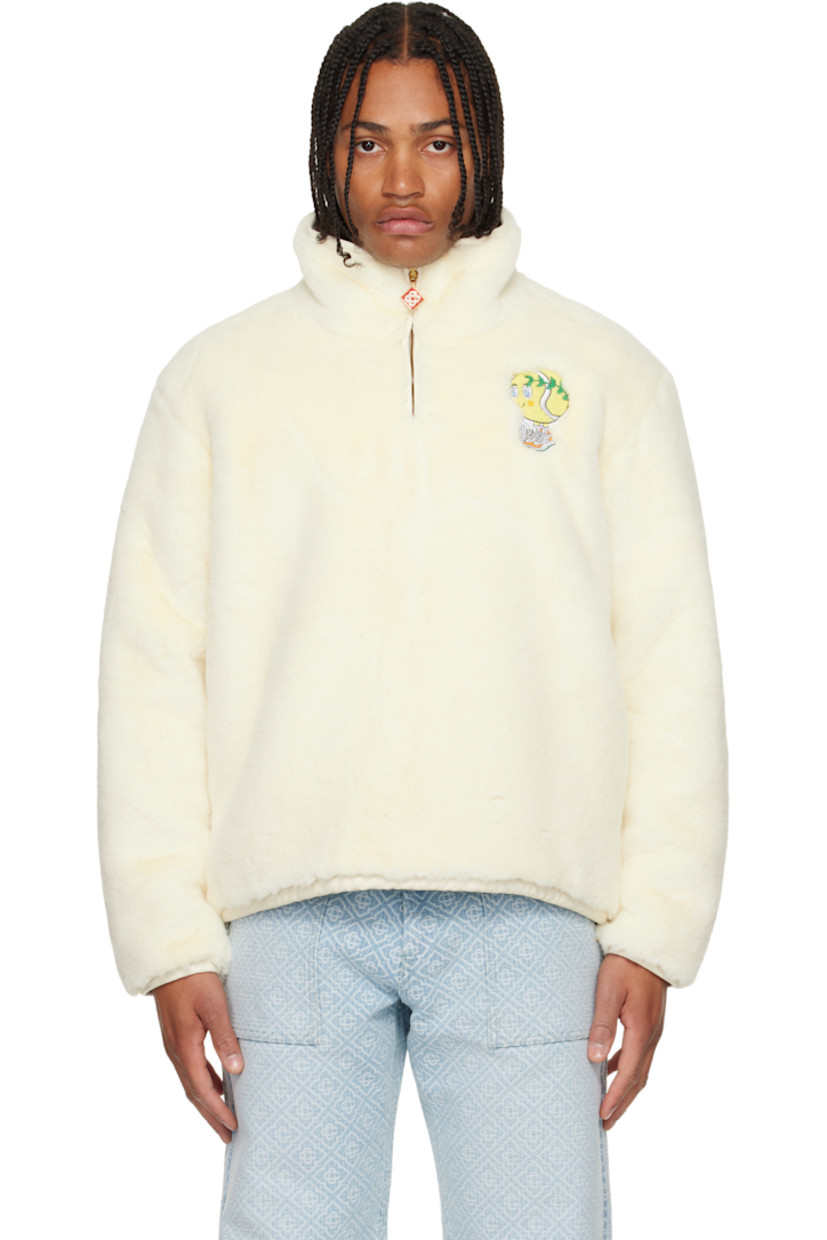 Faux-fur jacket. 

· Stand collar 
· Half-zip closure 
· Embroidered graphic at chest
· Seam pockets at waist
· Bungee-style drawstring at elasticized hem 

Supplier color: White