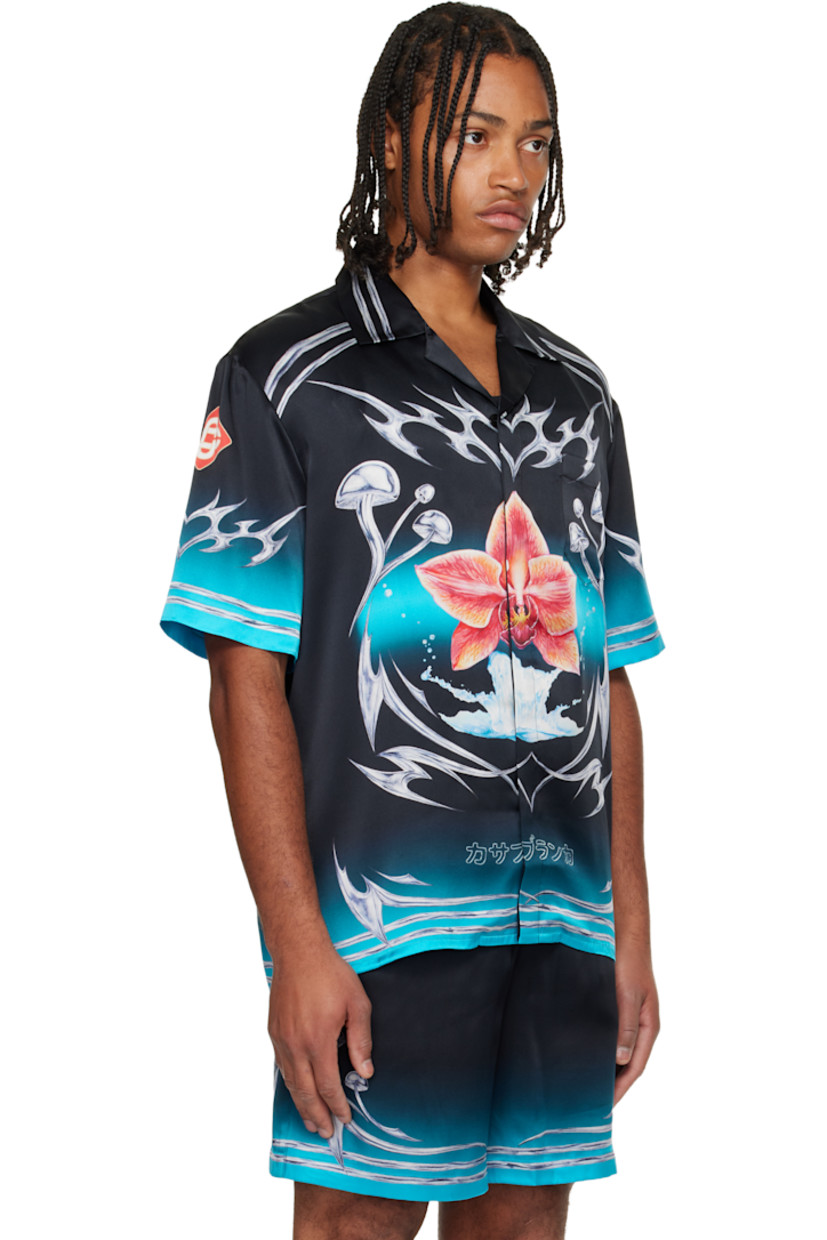 Silk satin shirt. 

· Graphic pattern printed throughout 
· Stripes and button tab at open spread collar 
· Button closure 
· Patch pocket at chest

Supplier color: Black