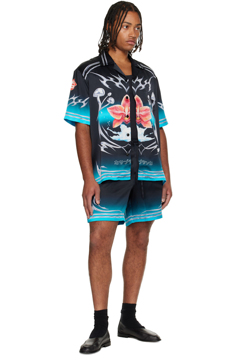 Silk satin shirt. 

· Graphic pattern printed throughout 
· Stripes and button tab at open spread collar 
· Button closure 
· Patch pocket at chest

Supplier color: Black