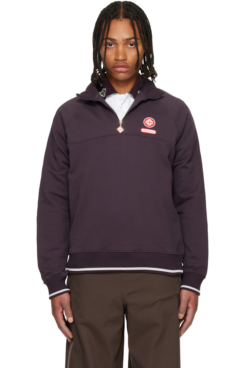 Organic cotton French terry sweatshirt. 

· Stripe at rib-knit stand collar, hem, and cuffs
· Half-zip closure
· Rubber logo patches at chest and back collar 
· Raglan sleeves 
· Piping and faille trim with floral pattern at sleeves

Supplier color: Burgundy