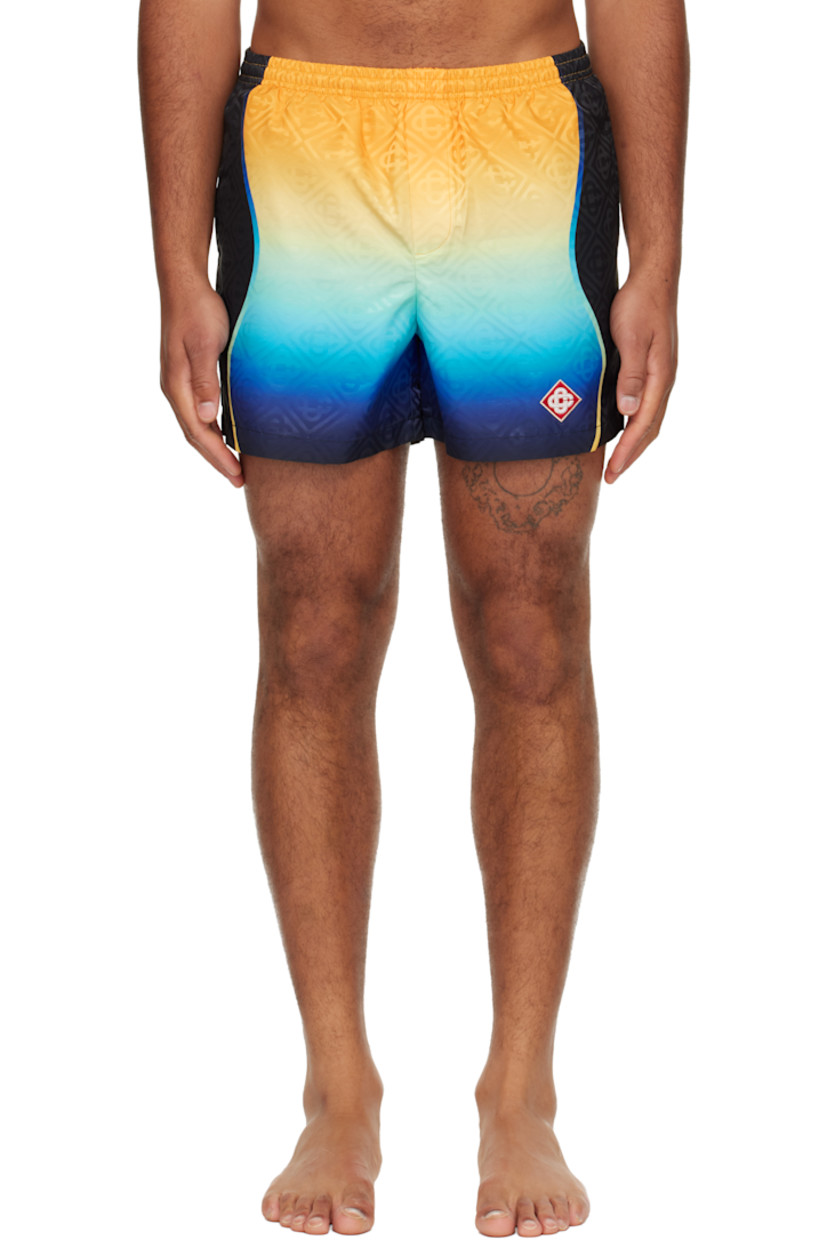 Taffeta swim shorts.

· Jacquard logo pattern and gradient throughout 
· Concealed drawstring at elasticized waistband
· Two-pocket styling
· Mock fly 
· Embroidered logo patch at front hem 
· Brief-style stretch mesh lining 

Supplier color: Multicolour