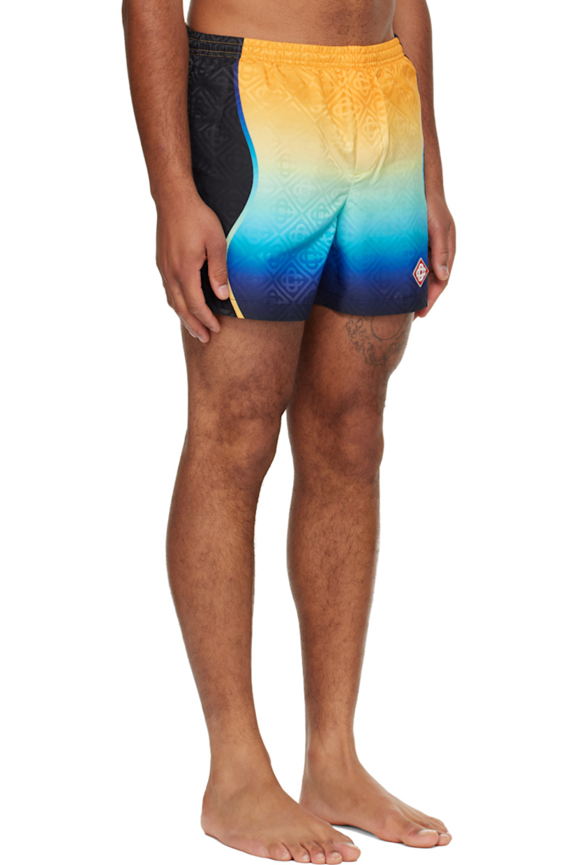 Taffeta swim shorts.

· Jacquard logo pattern and gradient throughout 
· Concealed drawstring at elasticized waistband
· Two-pocket styling
· Mock fly 
· Embroidered logo patch at front hem 
· Brief-style stretch mesh lining 

Supplier color: Multicolour