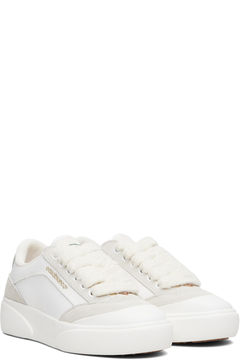 Low-top canvas and suede sneakers.

· Rubber cap toe
· Logo hardware at vamp
· Lace-up closure
· Text embroidered at padded tongue
· Padded collar
· Logo embroidered at outer side
· Mesh lining
· Treaded rubber sole

Supplier color: White