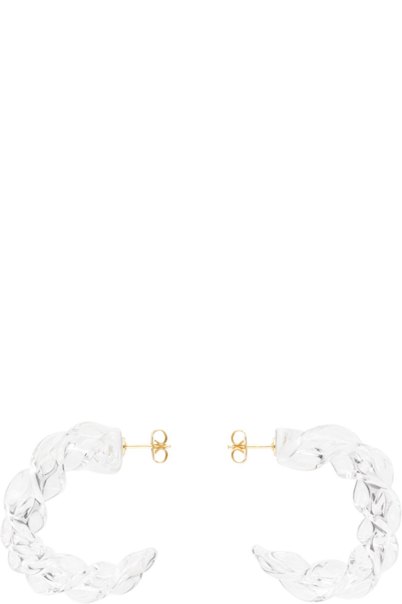 Pair of handcrafted open hoop earrings in transparent borosilicate glass.

· Twisted detailing throughout 
· Post-stud fastening 
· Gold-tone brass hardware
· D1.5"

Supplier color: Clear