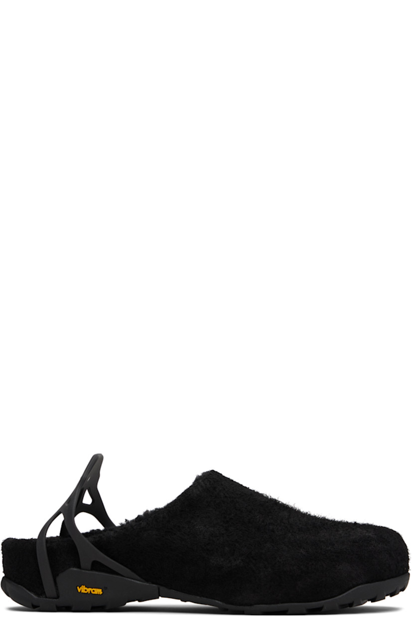 Handcrafted waxed calfskin suede slip-on loafers.

· Water-repellent
· Logo-embossed slingback strap
· Sherpa fleece lining
· Treaded Vibram® Megagrip rubber sole

Supplier color: Black sherpa
