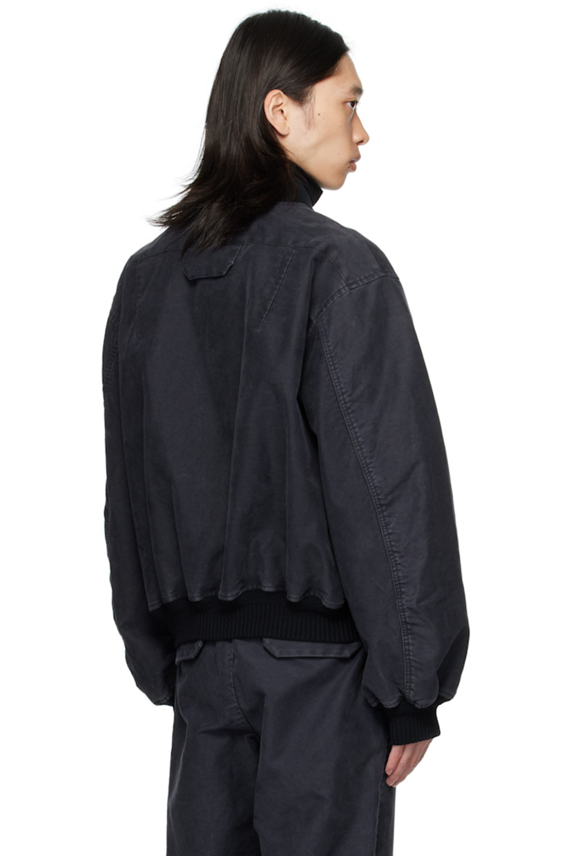 Cotton twill bomber jacket.

· Fading throughout
· Rib-knit stand collar, hem, and cuffs
· Two-way zip closure
· Zip pocket at chest
· Welt pockets at front
· Thumbhole at cuffs
· Flap pocket at back yoke
· Welt pockets at interior
· Full twill lining

Supplier color: Black