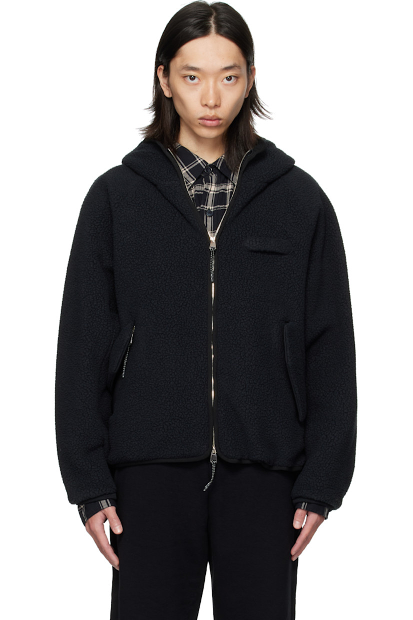 Sherpa fleece jacket. 

· Two-way zip closure
· Strap at chest 
· Flap pockets at waist 
· Bungee-style drawstring at hem 
· Raglan sleeves
· Elasticized cuffs
· Welt pockets at interior 
· Twill lining

Supplier color: Black