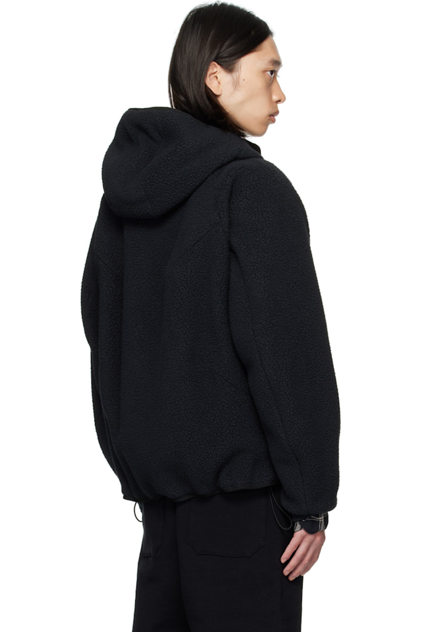 Sherpa fleece jacket. 

· Two-way zip closure
· Strap at chest 
· Flap pockets at waist 
· Bungee-style drawstring at hem 
· Raglan sleeves
· Elasticized cuffs
· Welt pockets at interior 
· Twill lining

Supplier color: Black
