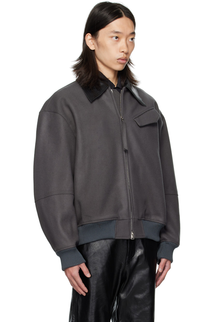 Wool melton jacket.

· Grained leather spread collar
· Two-way zip closure
· Flap pocket at chest and back yoke
· Seam pockets at waist
· Rib-knit hem and cuffs
· Welt pockets at interior
· Full twill lining

Supplier color: Concrete