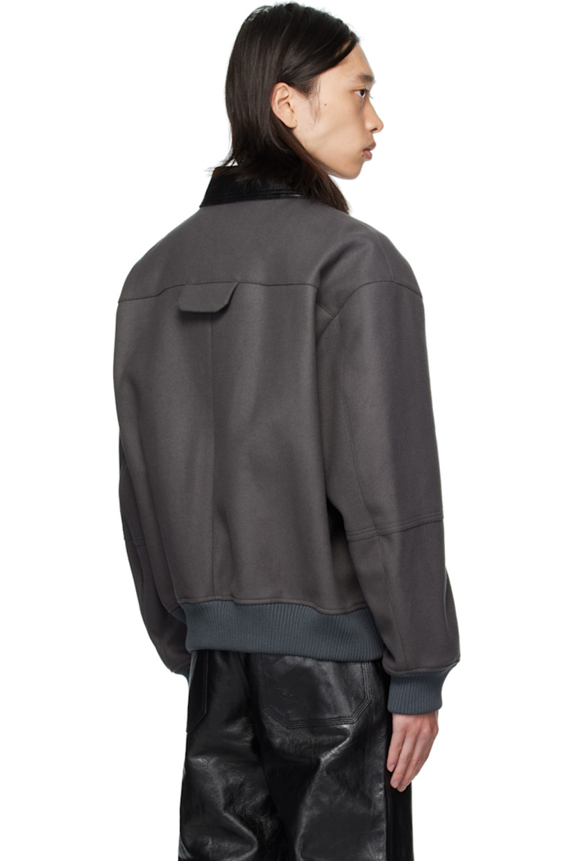 Wool melton jacket.

· Grained leather spread collar
· Two-way zip closure
· Flap pocket at chest and back yoke
· Seam pockets at waist
· Rib-knit hem and cuffs
· Welt pockets at interior
· Full twill lining

Supplier color: Concrete