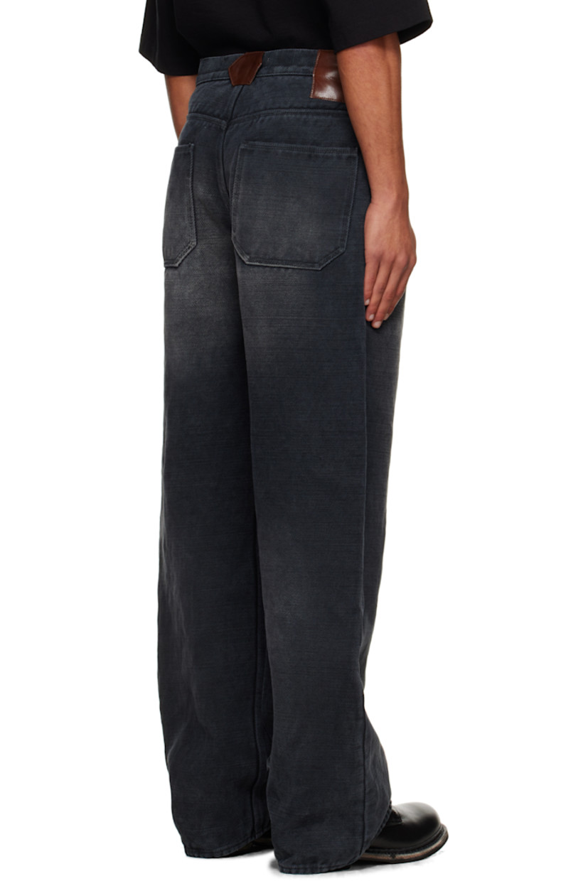 Non-stretch cotton- and jute-blend selvedge denim jeans. 

· Fading throughout 
· Belt loops
· Four-pocket styling
· Zip fly 
· Grained leather appliqués at back waistband

Supplier color: Faded black