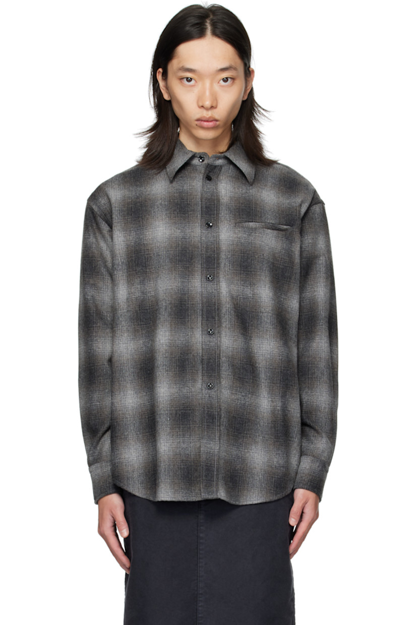 Wool-blend flannel shirt.

· Check pattern throughout
�· Spread collar
· Button closure
· Welt pocket at chest
· Shirttail hem
· Buttoned barrel cuffs
· Flap pocket and pleats at back yoke

Supplier color: Black