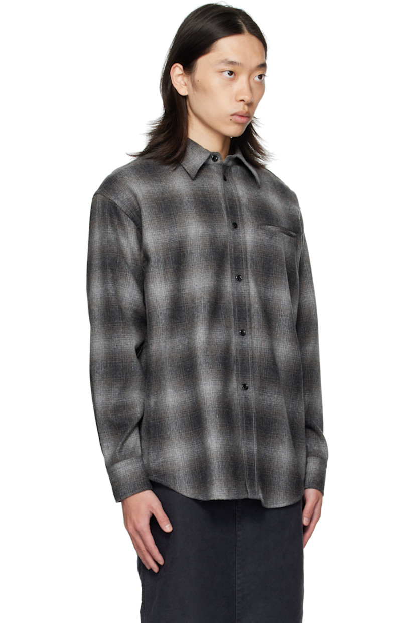 Wool-blend flannel shirt.

· Check pattern throughout
· Spread collar
· Button closure
· Welt pocket at chest
· Shirttail hem
· Buttoned barrel cuffs
· Flap pocket and pleats at back yoke

Supplier color: Black