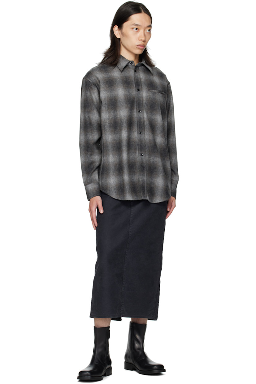 Wool-blend flannel shirt.

· Check pattern throughout
· Spread collar
· Button closure
· Welt pocket at chest
· Shirttail hem
· Buttoned barrel cuffs
· Flap pocket and pleats at back yoke

Supplier color: Black