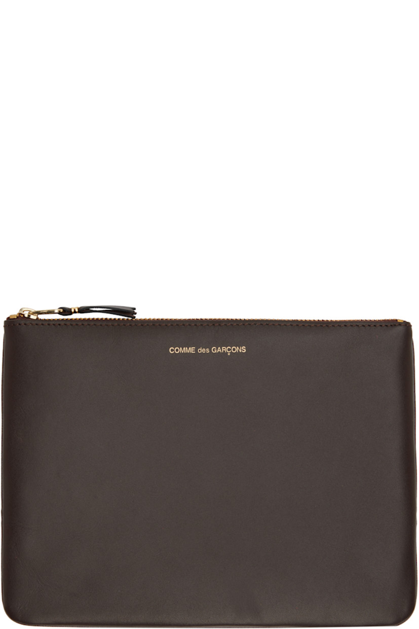 Buffed leather pouch in brown. 

· Logo stamp at face
· Zip closure
· Unlined
· H6.25" x W8.5"

Supplier color: Brown