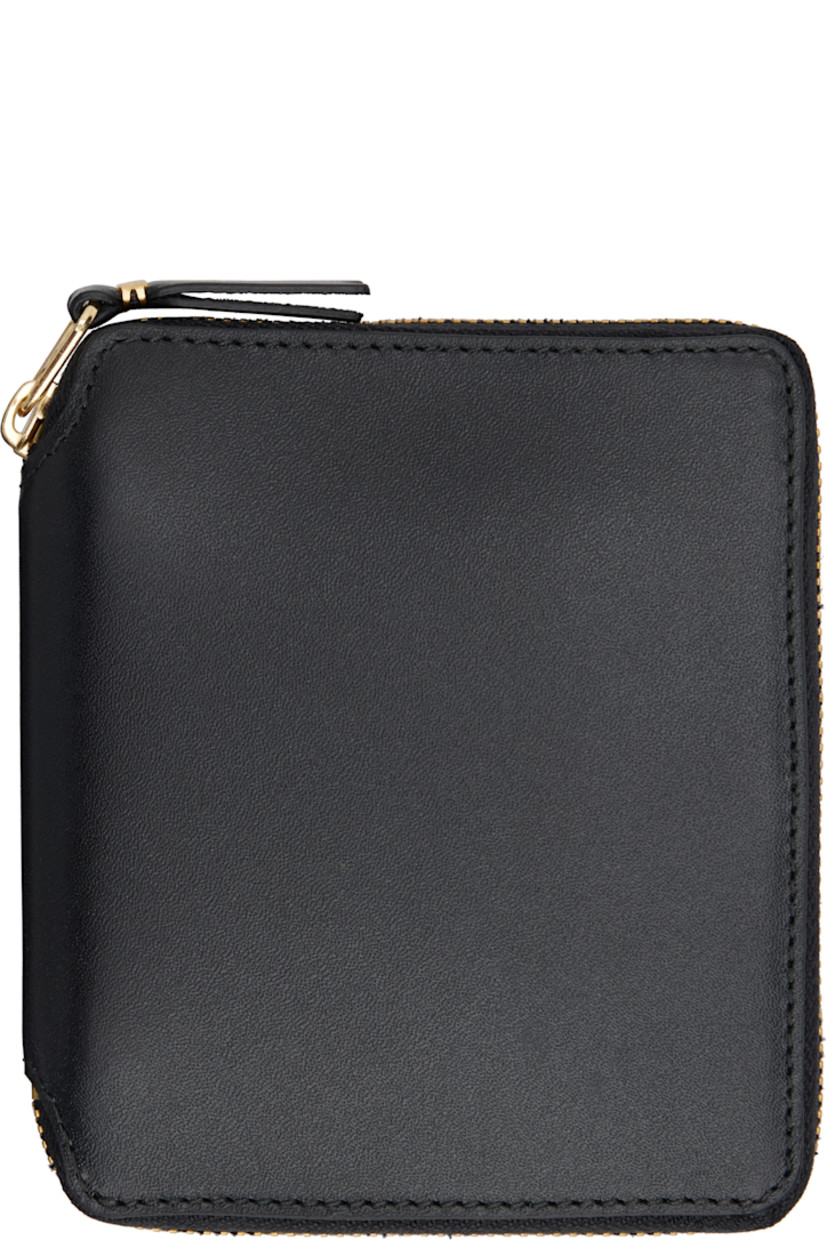 Buffed leather wallet in black.

· Zip closure
· Four card slots
· One patch pocket
· One note slot
· Press-stud coin compartment
· Grained leather lining
· H5" x W4.25" x D1"

Supplier color: Black